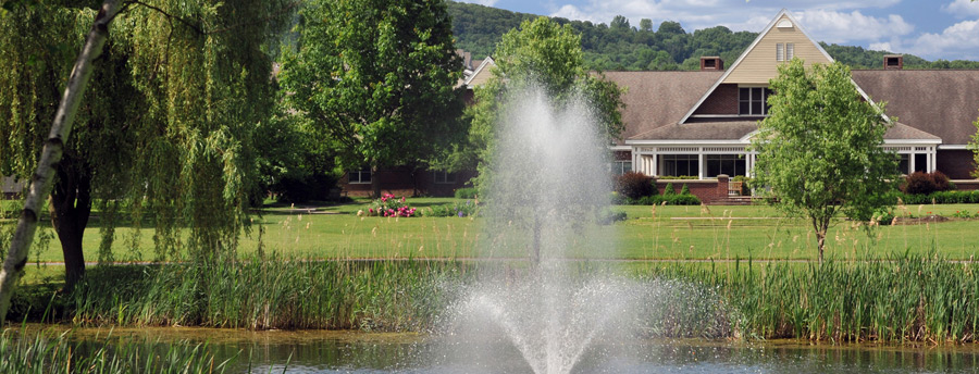 Pond with a beautiful fountain on scenic Acacia Village grounds